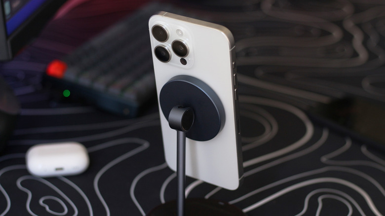 An iPhone on a MagSafe charging stand.