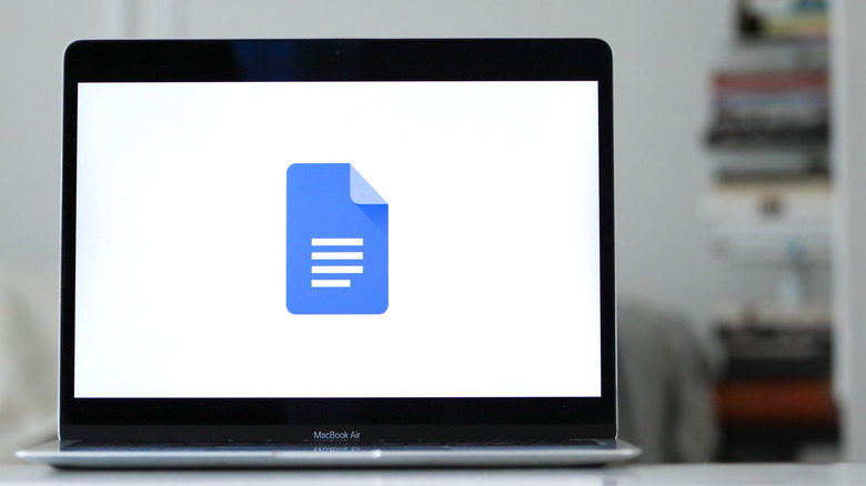Google Docs logo displayed on a MacBook Air.
