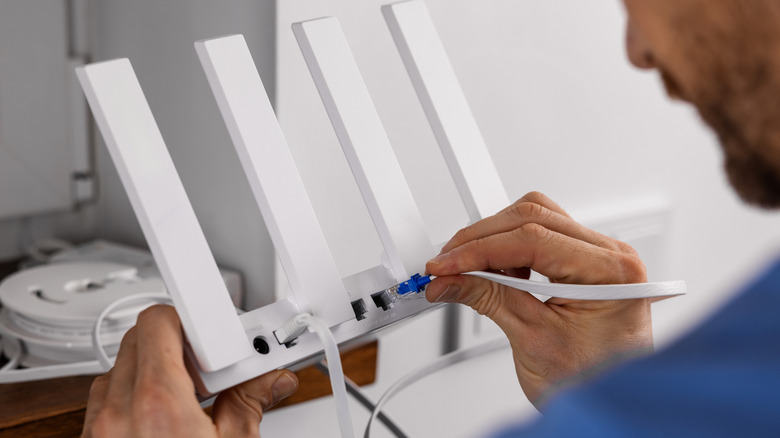 Service technician working on a Wi-Fi router.