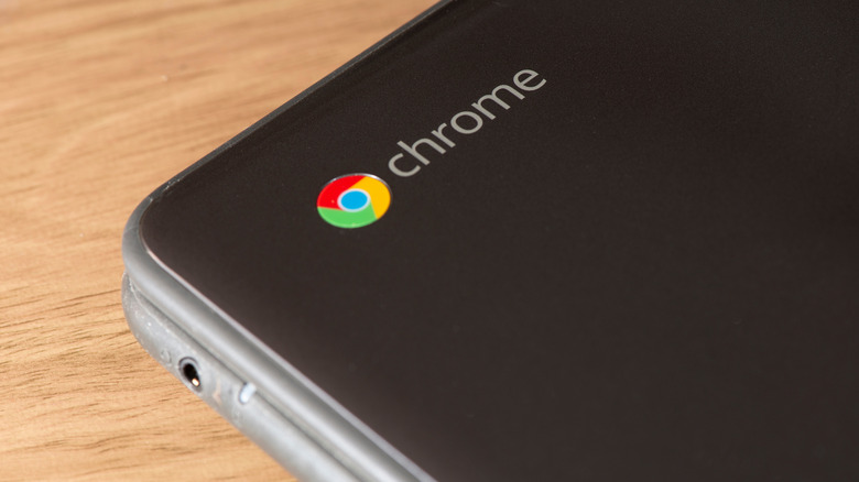 An up-close photo of the Chrome logo on the corner of a Chromebook.
