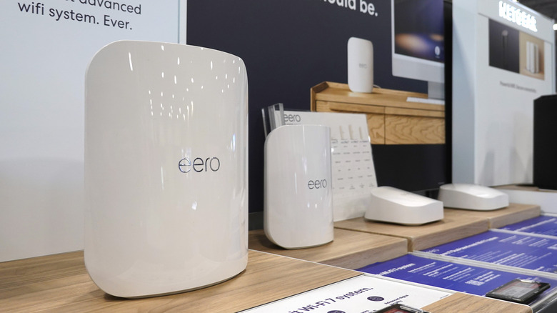 Several Eero Wi-Fi routers showcased in a store display.