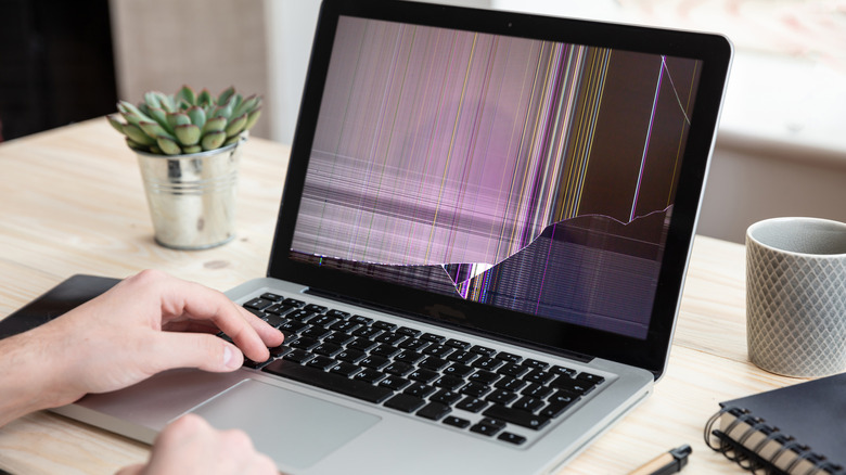 A MacBook with a broken screen.