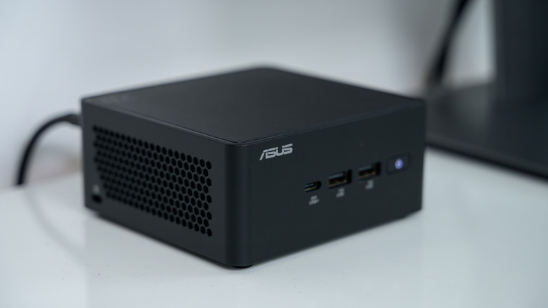ASUS NUC mini PC on a white desk.