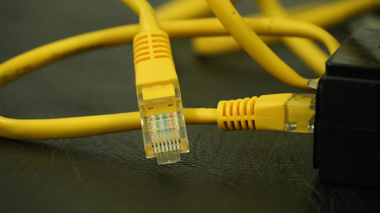 Yellow Ethernet cables connecting to a device.