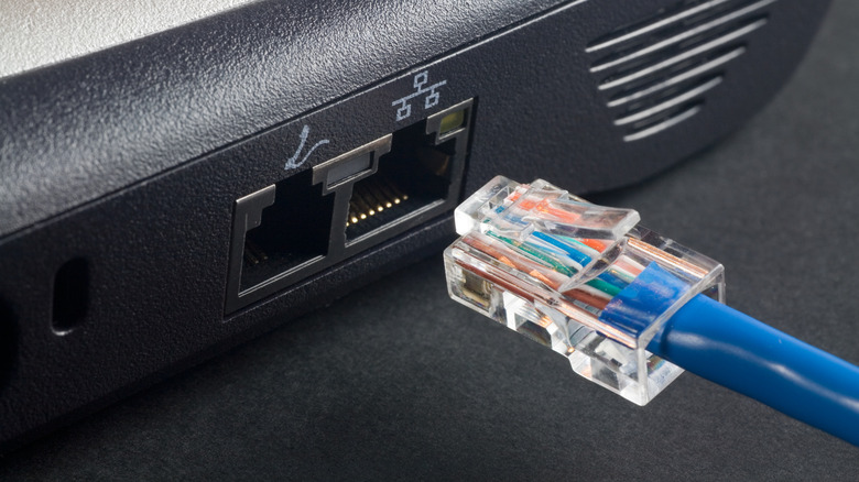 An extreme close-up of an Ethernet cable jacking into a laptop.
